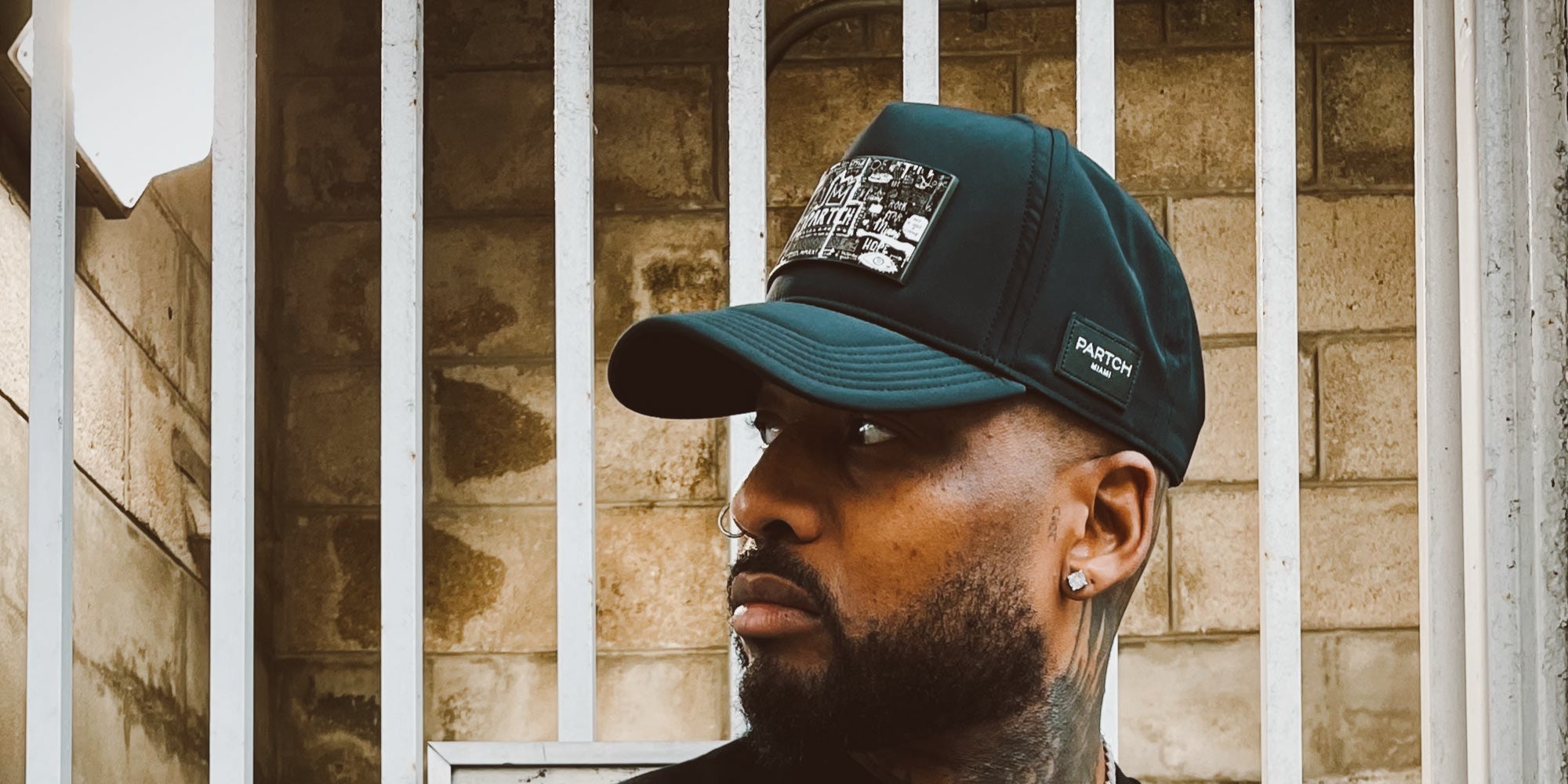 Black mesh trucker hat for men with structured front panel by PARTCH