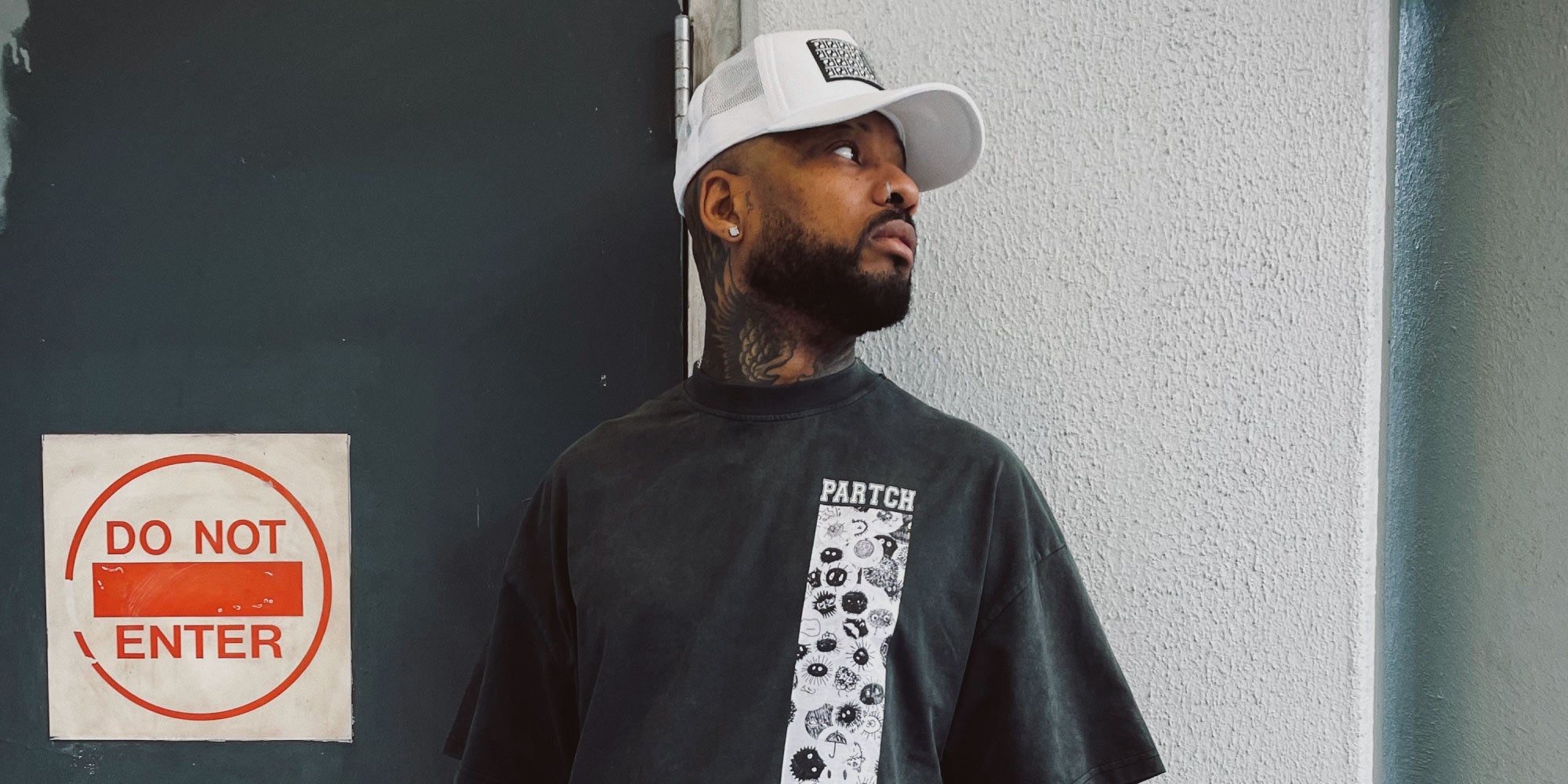 Black Man Wearing Designer Oversized Tee with White Trucker Hat | PARTCH