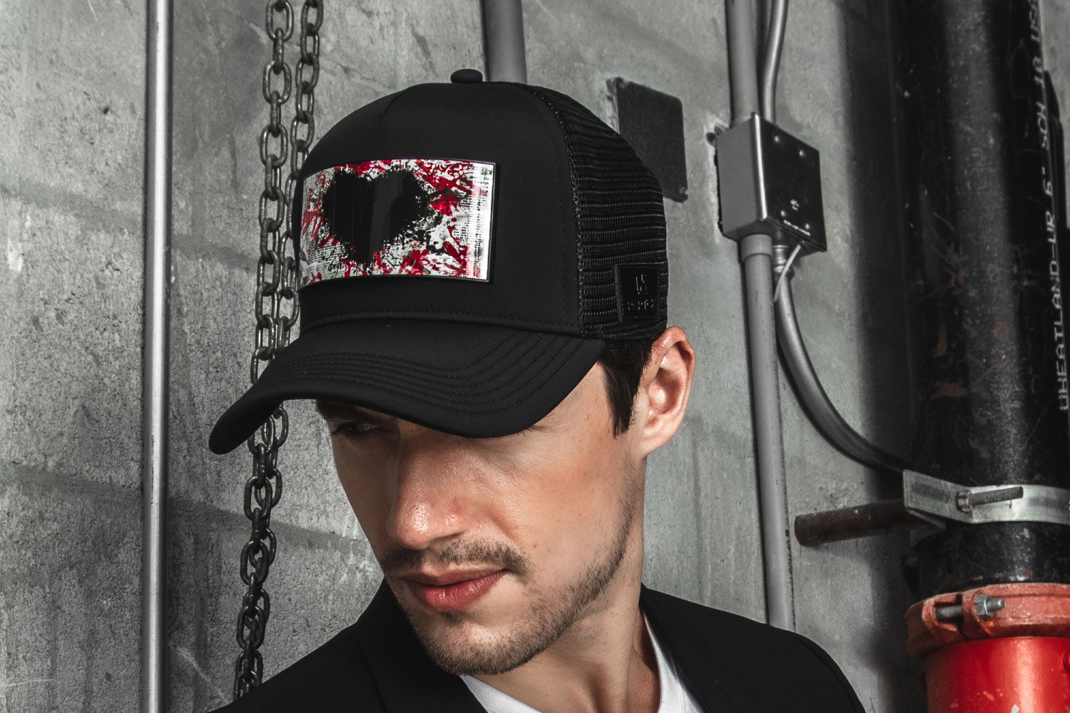 Man suit black jacket and trucker hat heart red 