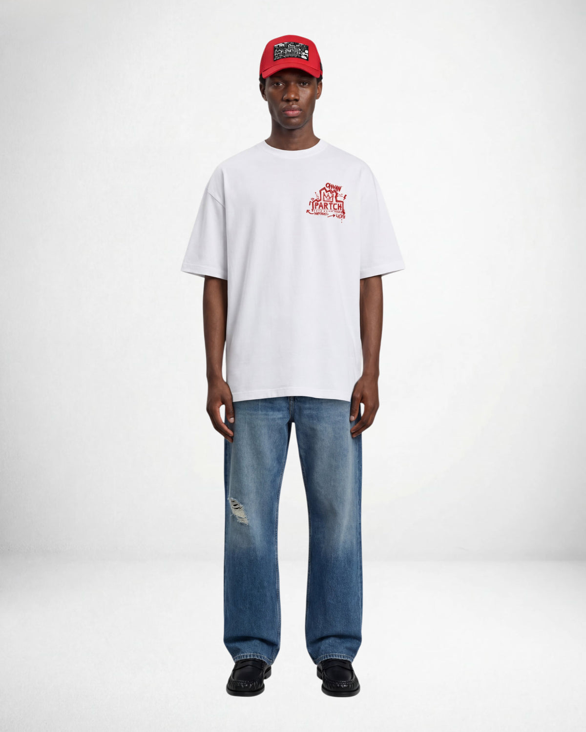 Man wearing a luxury white oversized t-shirt crown graphic with blue relaxed jeans denim | PARTCH