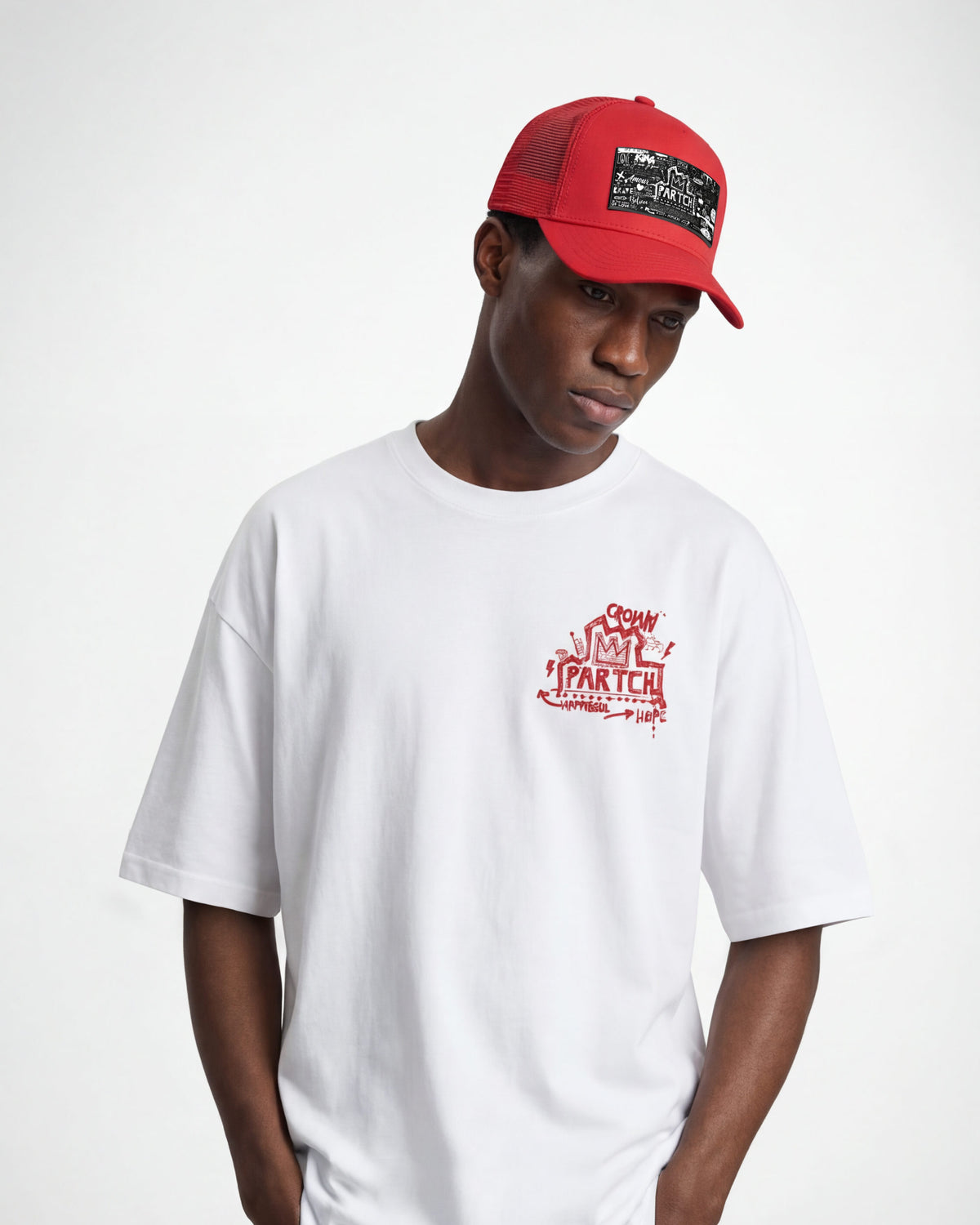 Man wearing red trucker hat and white luxury t-shirt Crown graphic cotton | PARTCH