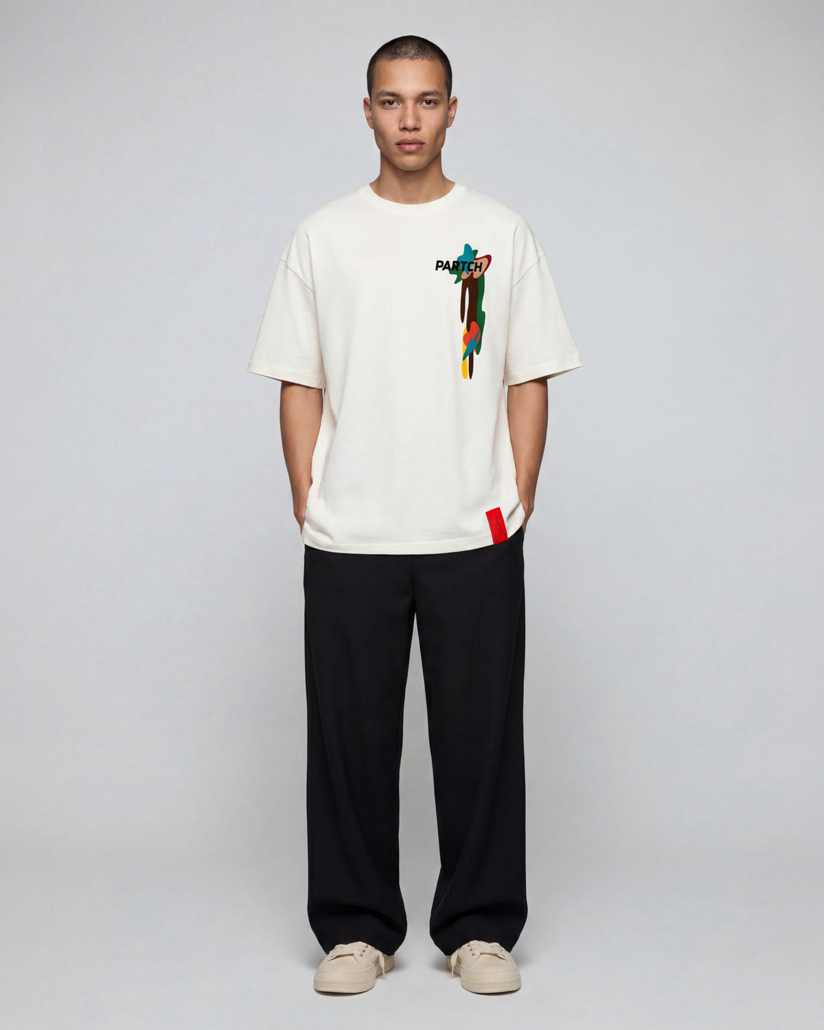 Man Wearing Black Pant with Luxury Cream Drift Graphic T-Shirt Oversized Tee Organic Cotton | PARTCH