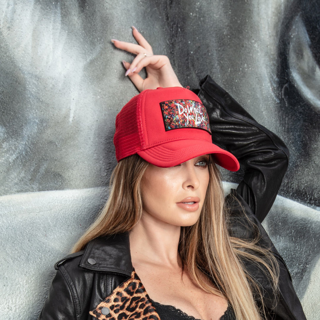 Woman fashion leather jacket and luxury red trucker hat Partch Do What You Love