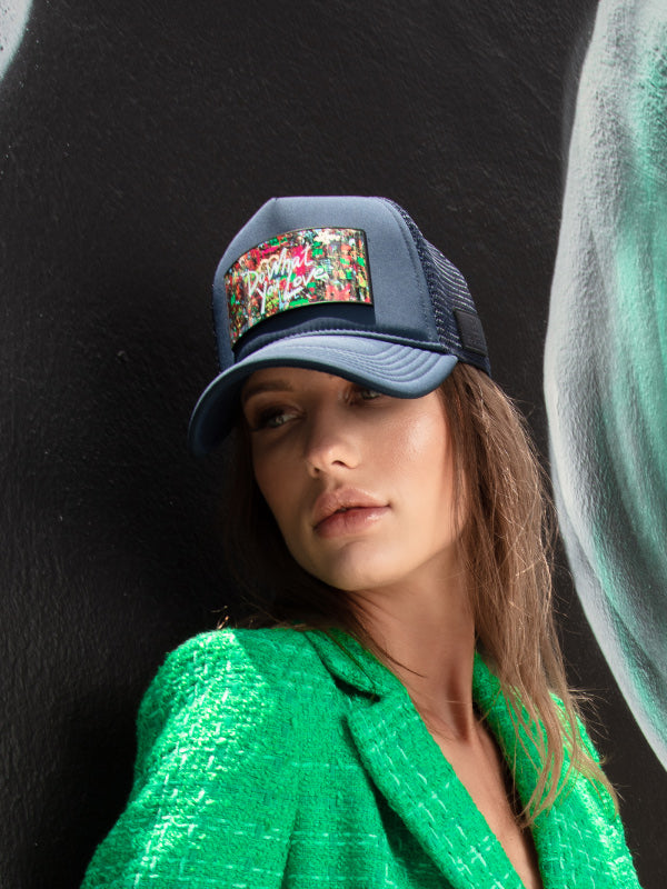 Woman with green jacket casual chic, and navy blue trucker hat Art Do What You Love