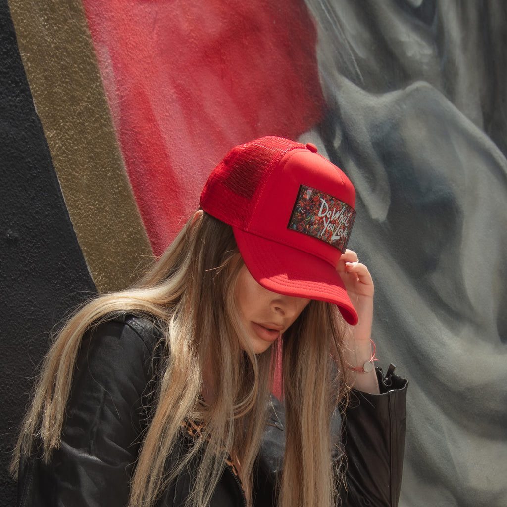 Woman black leather jacket and fashion red trucker hat Do What You Love